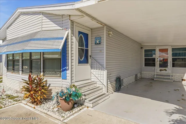 a view of a house with potted plants