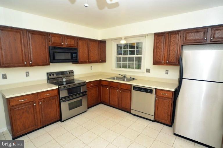 2207 Aventurine Way Silver Spring, MD 20904 - Photo 2 of 27 a kitchen with stainless steel appliances granite countertop a refrigerator stove a sink dishwasher and wooden cabinets