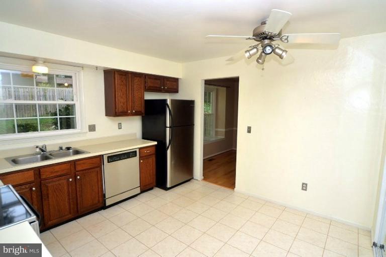 2207 Aventurine Way Silver Spring, MD 20904 - Photo 12 of 27 a kitchen with stainless steel appliances a sink cabinets and refrigerator