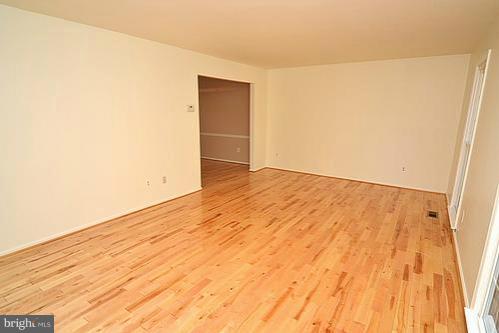 2207 Aventurine Way Silver Spring, MD 20904 - Photo 13 of 27 an empty room with wooden floor