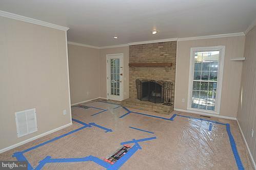 2207 Aventurine Way Silver Spring, MD 20904 - Photo 14 of 27 an empty room with furniture and a fireplace