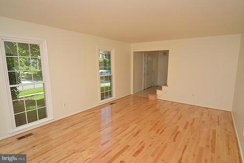 2207 Aventurine Way Silver Spring, MD 20904 - Photo 18 of 27 a view of an empty room with wooden floor and a window