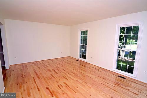 2207 Aventurine Way Silver Spring, MD 20904 - Photo 19 of 27 a view of empty room with wooden floor and fan