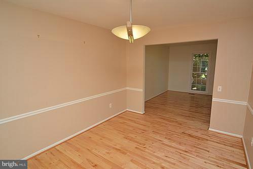 2207 Aventurine Way Silver Spring, MD 20904 - Photo 9 of 27 a view of an empty room with wooden floor and a window