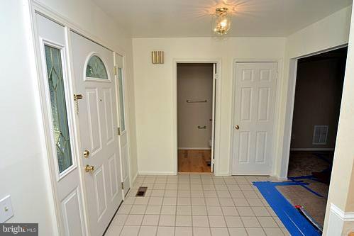 2207 Aventurine Way Silver Spring, MD 20904 - Photo 10 of 27 a view of a hallway with wooden floor and a bathroom