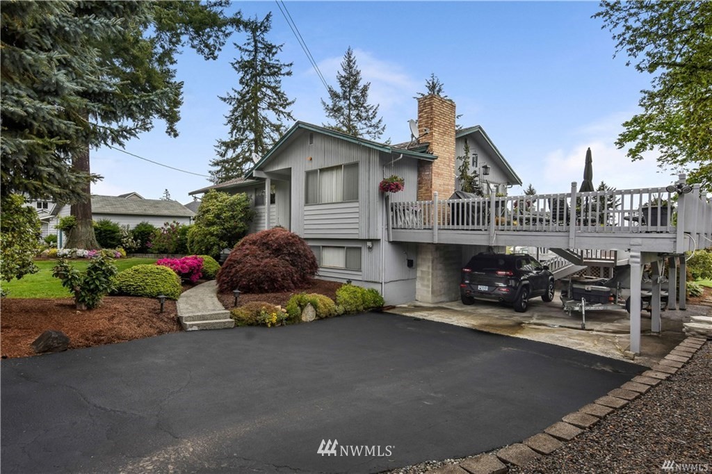 21325 1st Avenue West Bothell, WA 98021 - Photo 4 of 17 a front view of a house with sitting area and garden