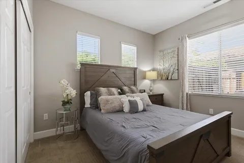 a bedroom with a bed and window