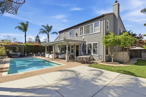 a view of a backyard with swimming pool