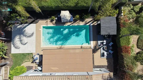 an aerial view of a house with garden space and street view