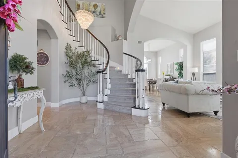 a living room with furniture and a chandelier