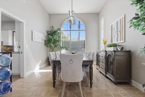 a dining room with furniture and window