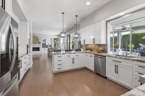a kitchen with white cabinets and stainless steel appliances