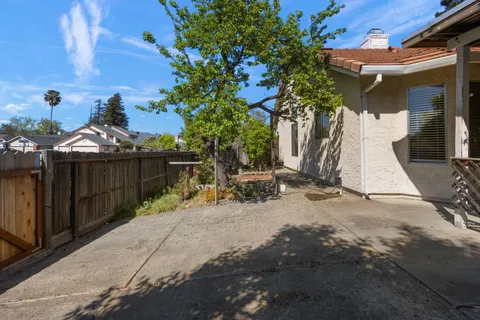 a view of backyard with wooden fence