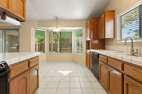 a kitchen with a sink stove and cabinets