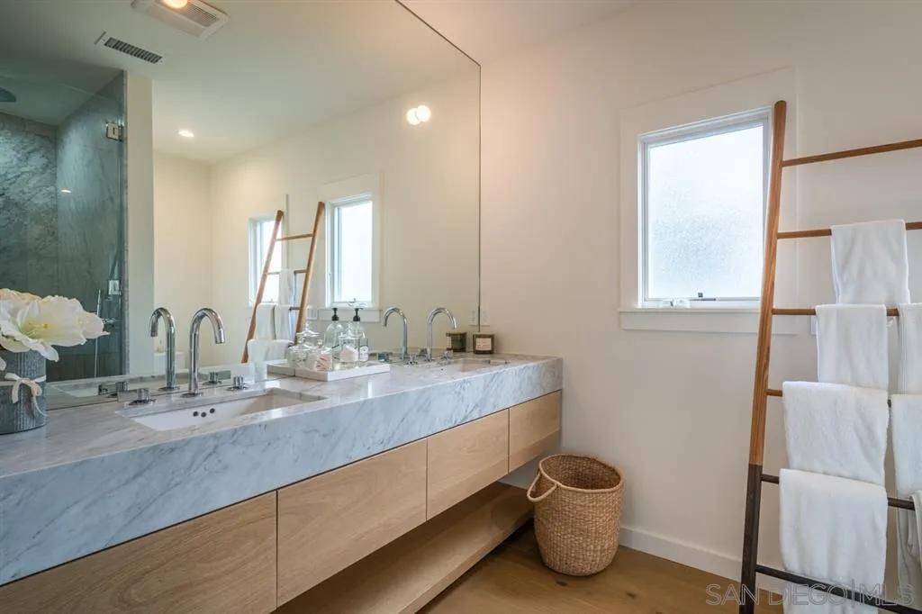 370 Glorietta Boulevard Coronado, CA 92118 - Photo 16 of 25 a bathroom with a double vanity sink and a mirror
