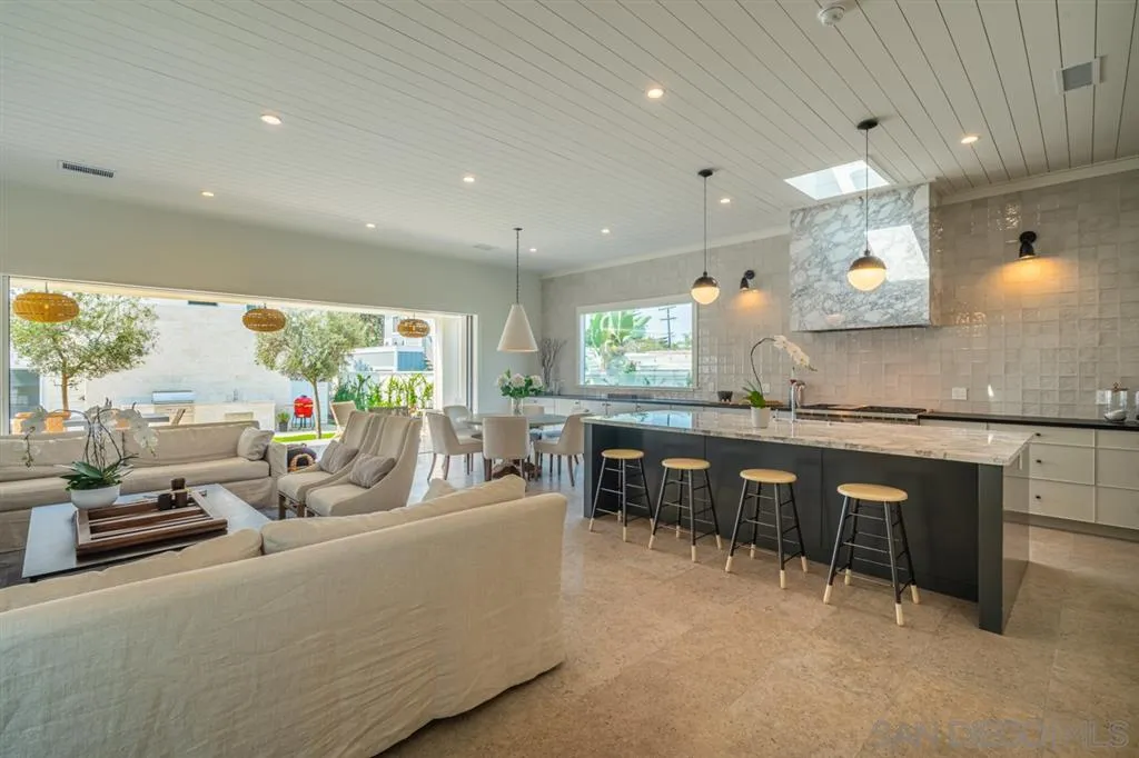 370 Glorietta Boulevard Coronado, CA 92118 - Photo 6 of 25 a living room with kitchen island furniture a large window and stainless steel appliances