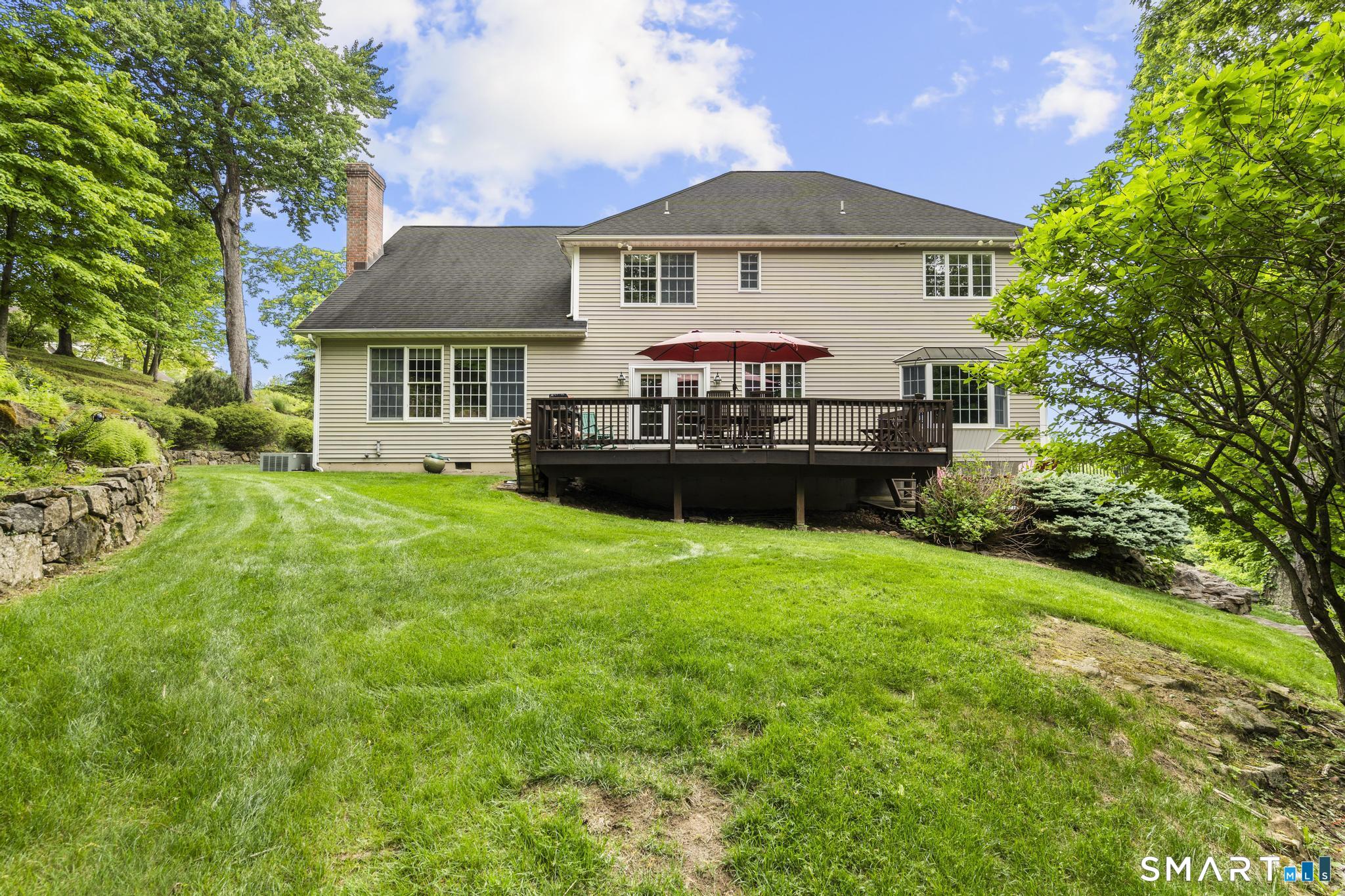 12 Logans Way Danbury, CT 06811 - Photo 35 of 40 a front view of a house with a garden