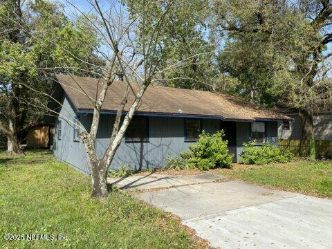 10321 Westmar Road Jacksonville, FL 32218 - Photo 2 of 7 a front view of a house with a yard and garage