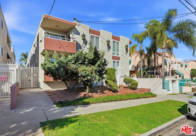 a front view of multi story residential apartment building with yard