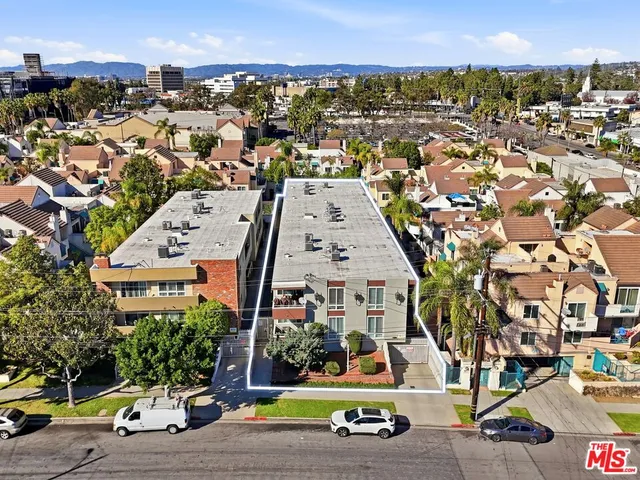 an aerial view of multiple houses with yard