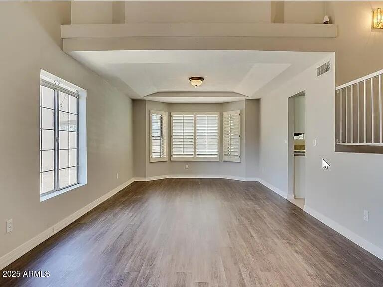 16625 South 34th Way Phoenix, AZ 85048 - Photo 10 of 36 an empty room with wooden floor and windows