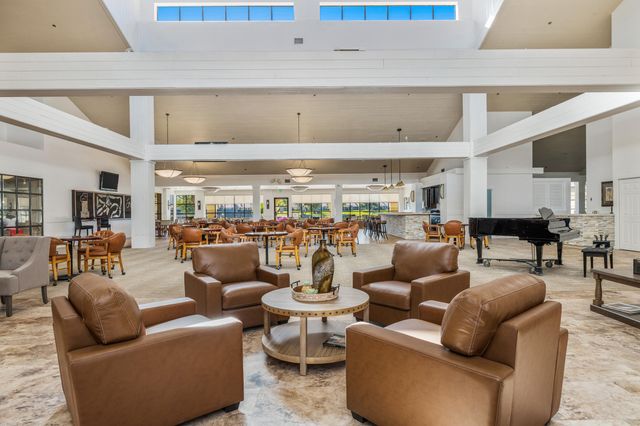 a living room with furniture and a view of kitchen