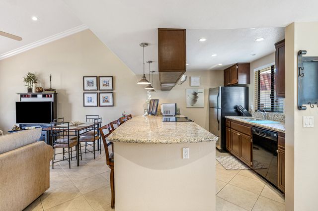 a large kitchen with a large counter top appliances and cabinets