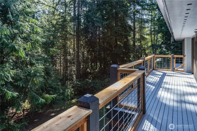 a balcony with wooden floor and outdoor space