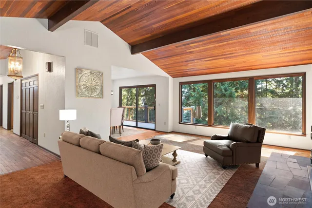 a living room with furniture and large windows