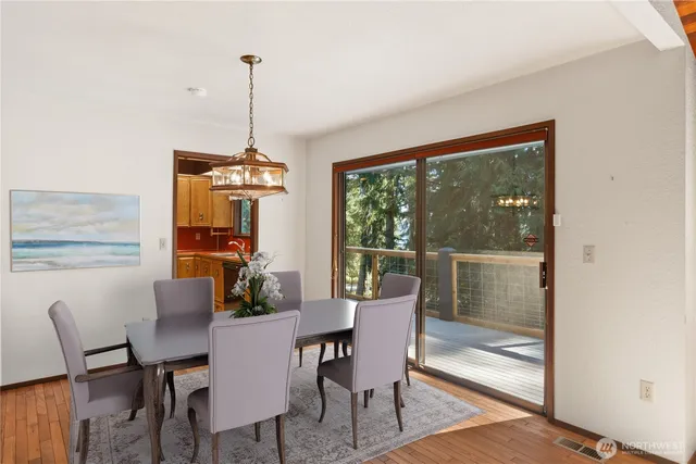 a dining room with furniture window and wooden floor