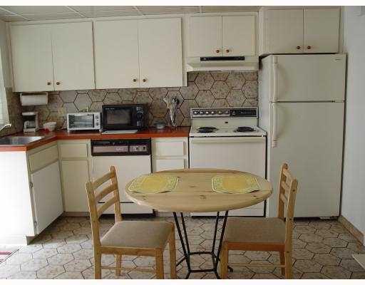 3308 Southeast 3rd Street Pompano Beach, FL 33062 - Photo 13 of 24 a kitchen with stainless steel appliances granite countertop a table chairs stove and refrigerator