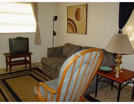 3308 Southeast 3rd Street Pompano Beach, FL 33062 - Photo 14 of 24 a living room with a couch and a flat screen tv