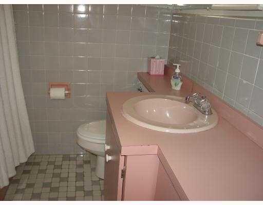 3308 Southeast 3rd Street Pompano Beach, FL 33062 - Photo 19 of 24 a bathroom with a sink a toilet and a mirror