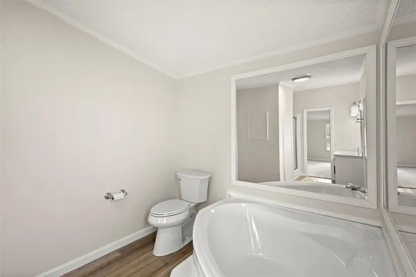 a spacious bathroom with a toilet and a mirror