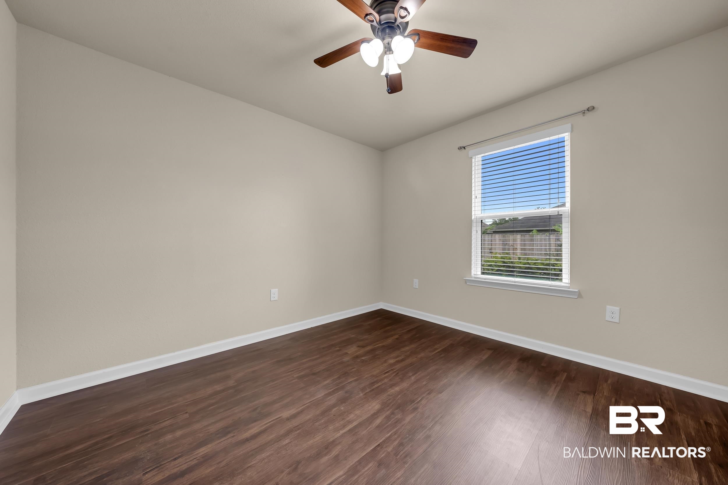 1704 Abbey Loop Foley, AL 36535 - Photo 24 of 38 Room featuring wood-finish flooring, neutral wall paint, and white baseboards