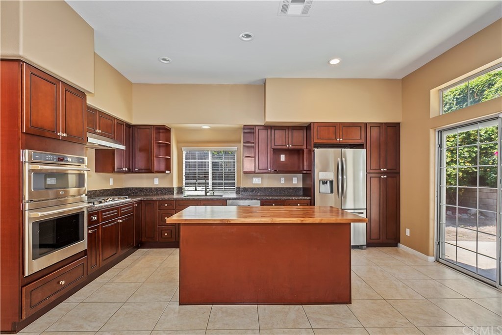 12358 High Horse Drive Rancho Cucamonga, CA 91739 - Photo 7 of 25 Sparkling new island kitchen features all new stainless steel appliances