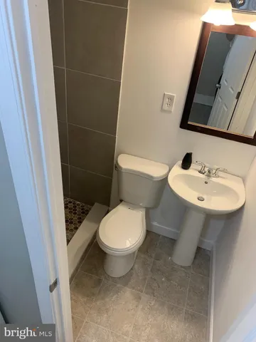 a white toilet sitting next to a bathroom sink