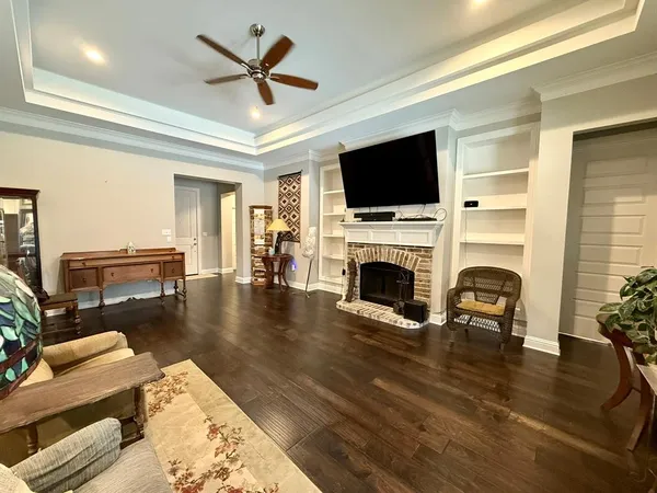 a living room with furniture a fireplace and a flat screen tv