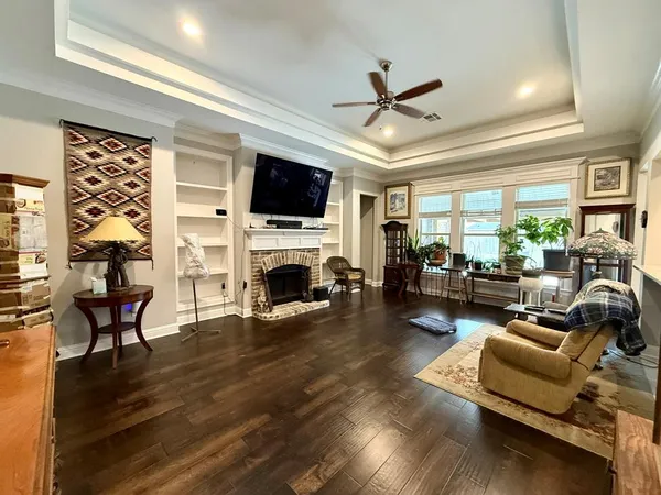 a living room with furniture a fireplace and a flat screen tv