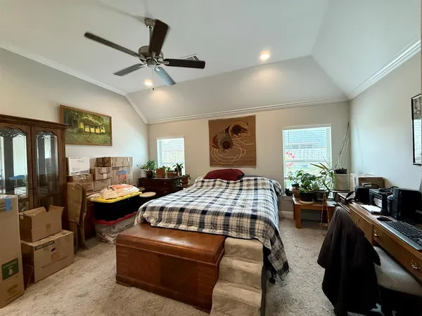 a bedroom with a bed and ceiling fan