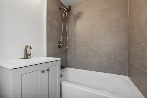 a bath room with a sink toilet and shower