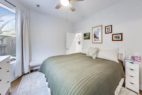 a bedroom with a bed and a window