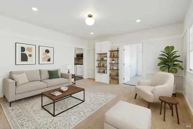 a living room with furniture and a potted plant
