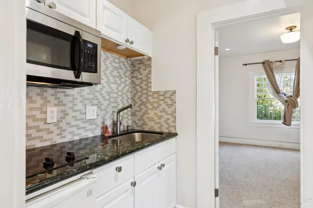 a kitchen with stainless steel appliances granite countertop a stove and a microwave