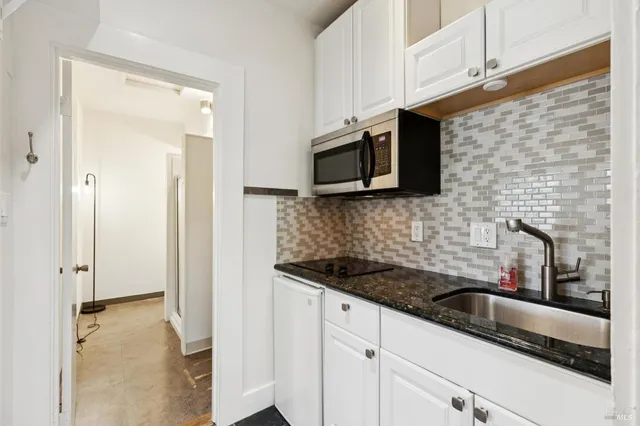 a kitchen with stainless steel appliances wooden cabinets and a sink