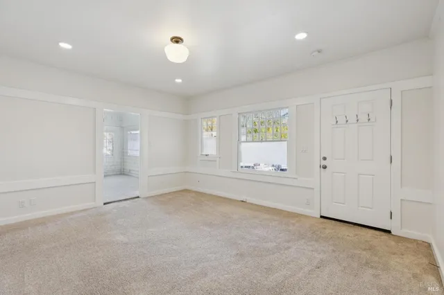 an empty room with a empty space and windows