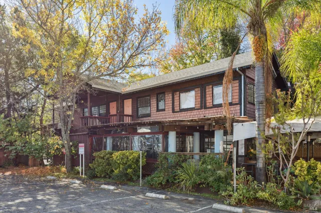 a front view of a residential apartment building with a yard