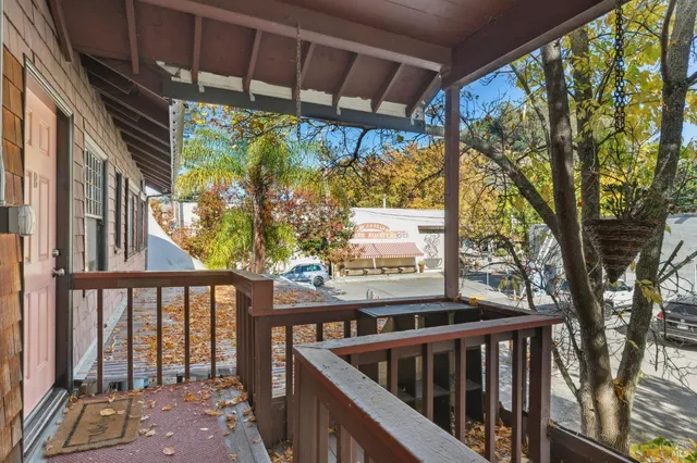 a view of balcony with wooden floor