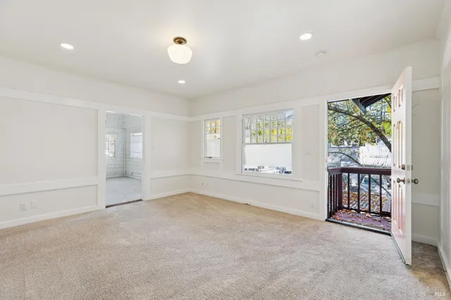 an empty room with windows and closet