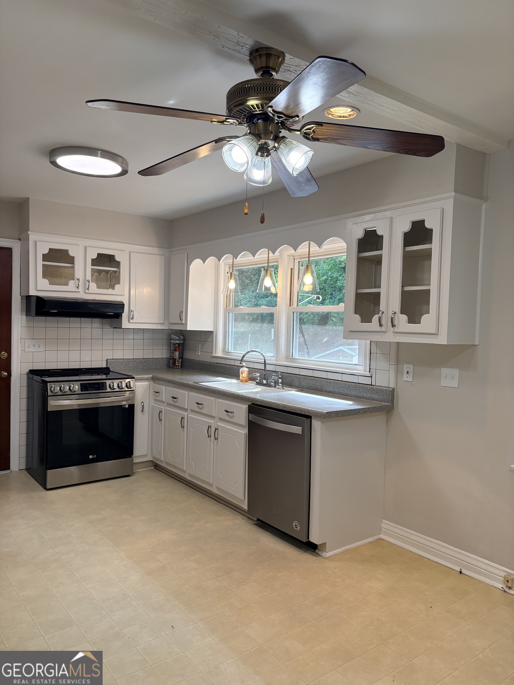 218 Flora Avenue Southeast Rome, GA 30161 - Photo 11 of 24 a kitchen with stainless steel appliances granite countertop a stove and a sink